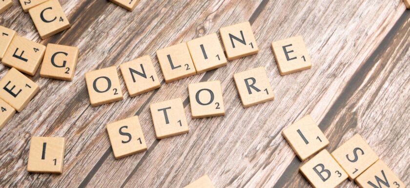 Scrabble tiles spelling 'online store' on a rustic wooden background.