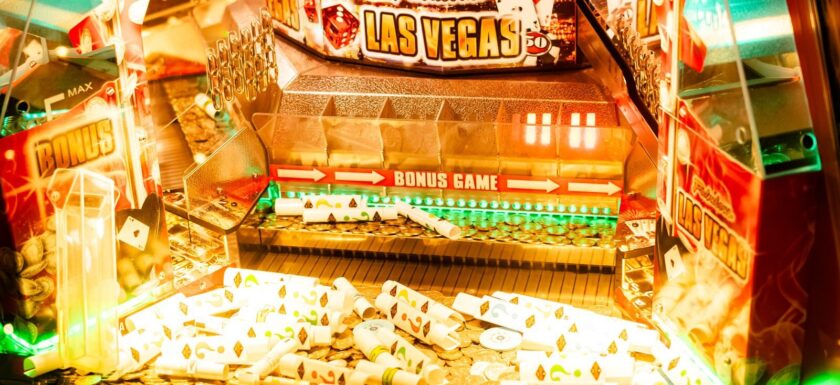 Colorful casino game machine featuring Las Vegas theme with coins and poker cards.